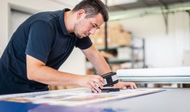 Color management. X-Rite handheld Spectrophotometer verify color, Print Measuring Tool X-Rite handheld spectrophotometer verify color patches, modern press shop prepress department.